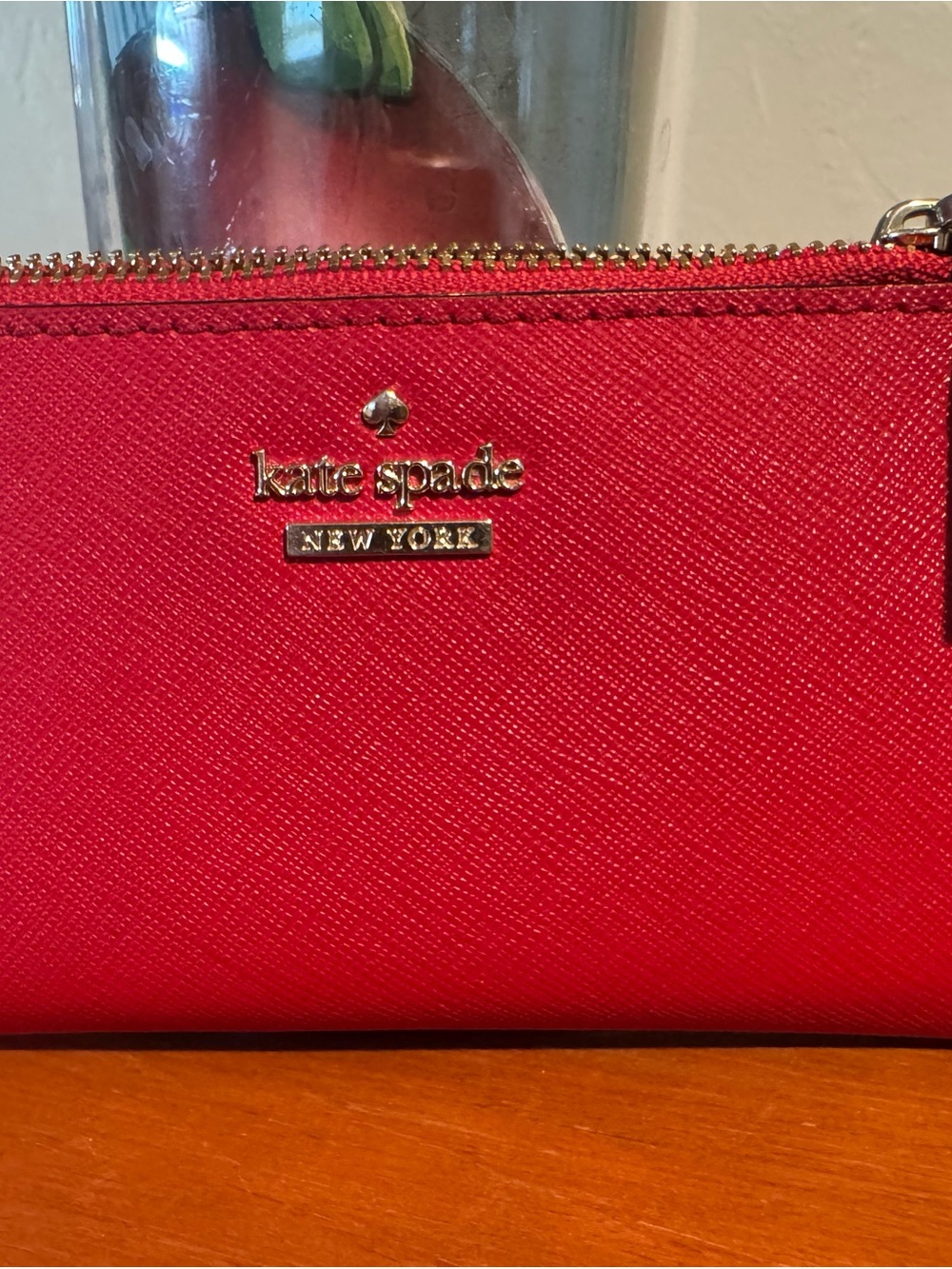 kate spade red Saffiano zip wallet with gold logo
